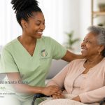 Caregiver in green scrubs smiling with a senior woman at home